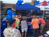 Volunteers and Patrons at The Blue Pledge Booth